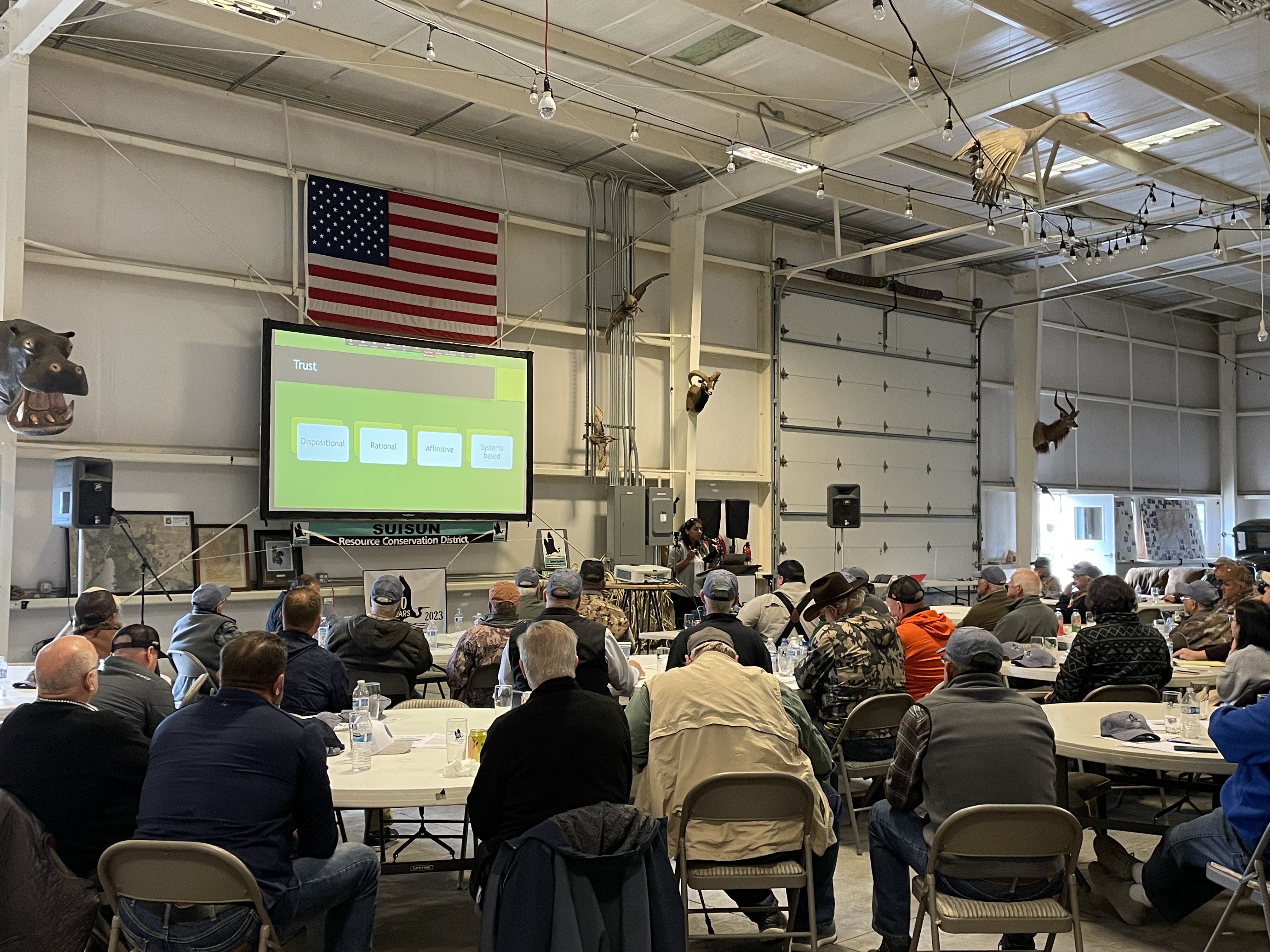 People sitting at tables participating in a workshop.